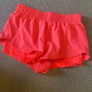 Pink running shorts with spandex underneath